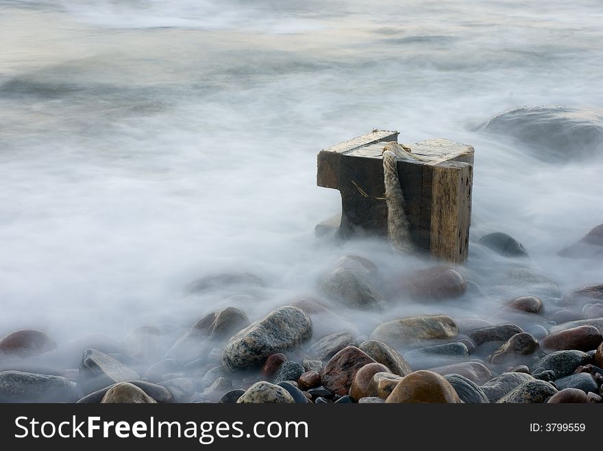 The cold dark blue sea, easy(light) fog, breakwater in the distance. The cold dark blue sea, easy(light) fog, breakwater in the distance.