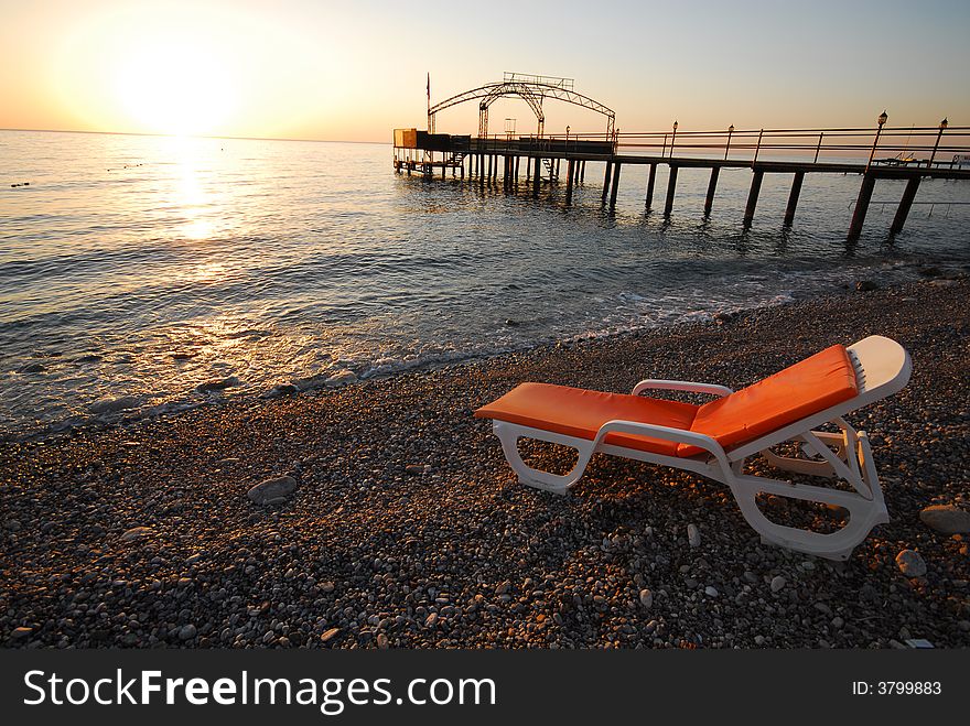 Small beach with chaise lounges on seacoast