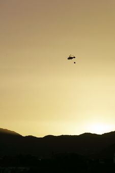 Firefighter Helicopter Flying At Sunset Royalty Free Stock Photography