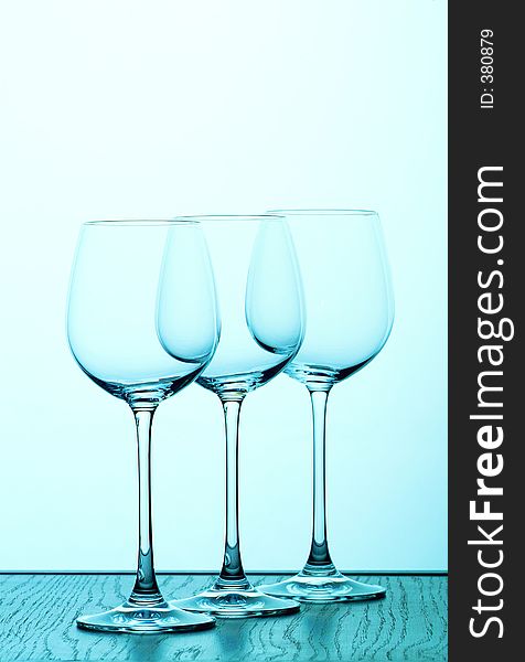 Three wine glasses in blue backlight. Three wine glasses in blue backlight