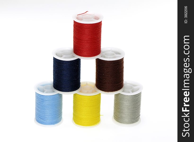 Multi colored pyramid of thread spools. Multi colored pyramid of thread spools