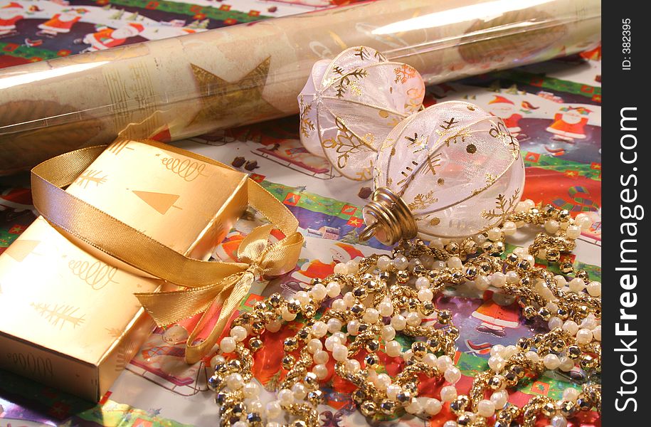 Baubles, beads, wrapping paper and ribbons for wrapping Christmas Giftsi. Baubles, beads, wrapping paper and ribbons for wrapping Christmas Giftsi