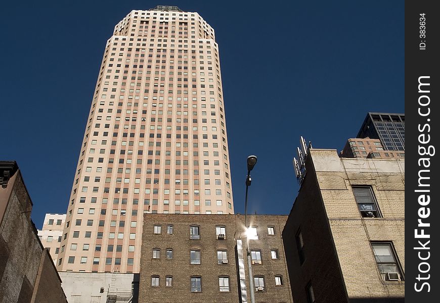 This is a shot of an apartment building in New York City against a rich blue sky. This is a shot of an apartment building in New York City against a rich blue sky.