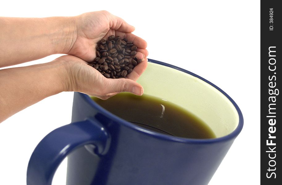 Isolated hand and coffee beans with a big mug. Isolated hand and coffee beans with a big mug