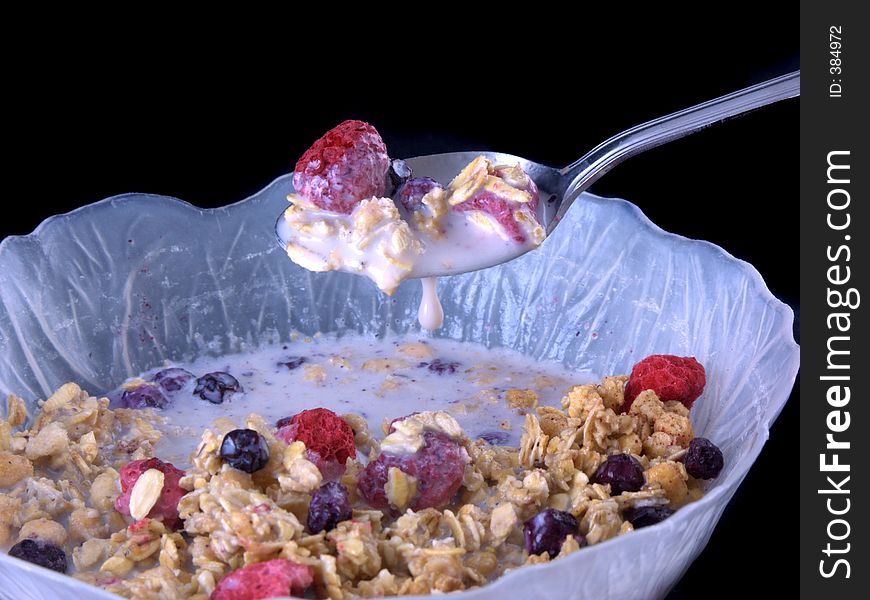 Bowl of cereal with milk dripping off spoon