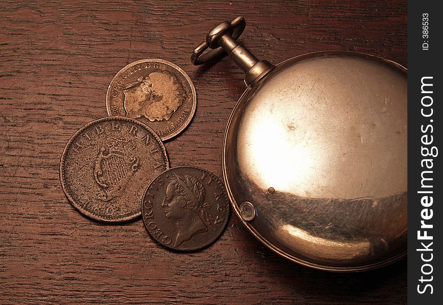 Old pocket watch and coins