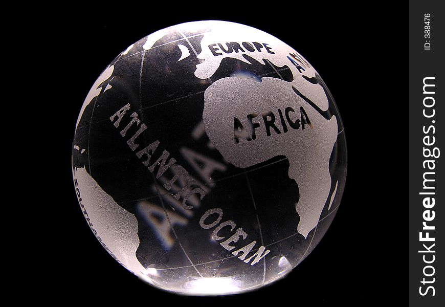 A glass globe showing africa, europe and atlantic ocean.