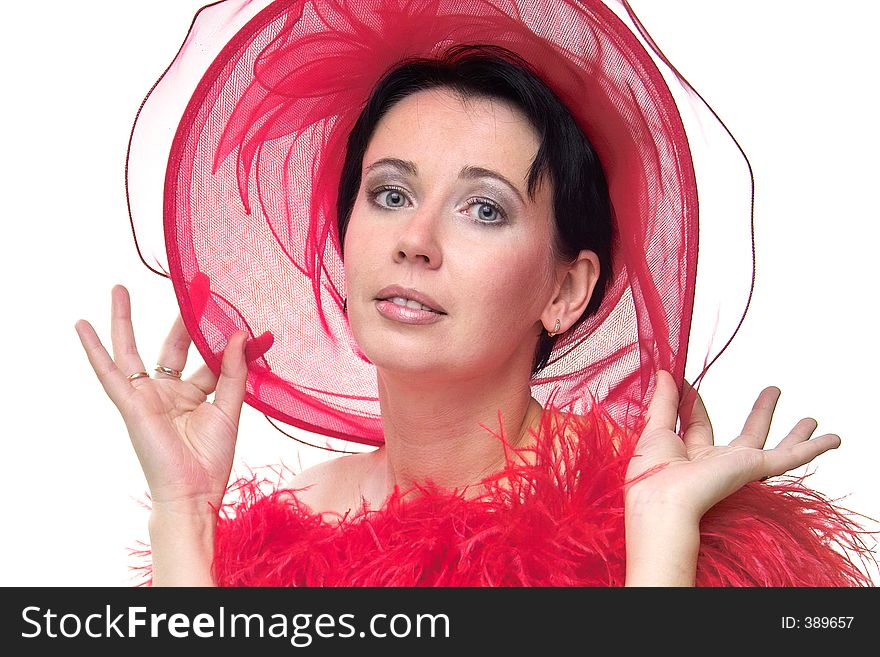 Portrait of a beautiful young woman wearing a red hat and feathered red boa over naked shoulders. Portrait of a beautiful young woman wearing a red hat and feathered red boa over naked shoulders