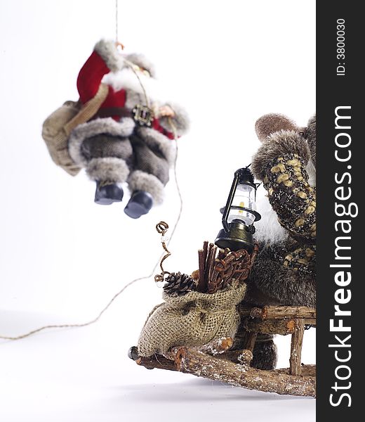 Photo of a  figurine on a wooden sleigh greeting Santa