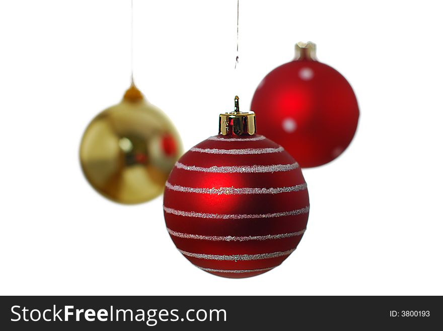 Three hanging Christmas baubles isolated on a white background. Three hanging Christmas baubles isolated on a white background