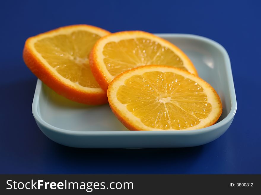 Close up of orange slices on a blue plate