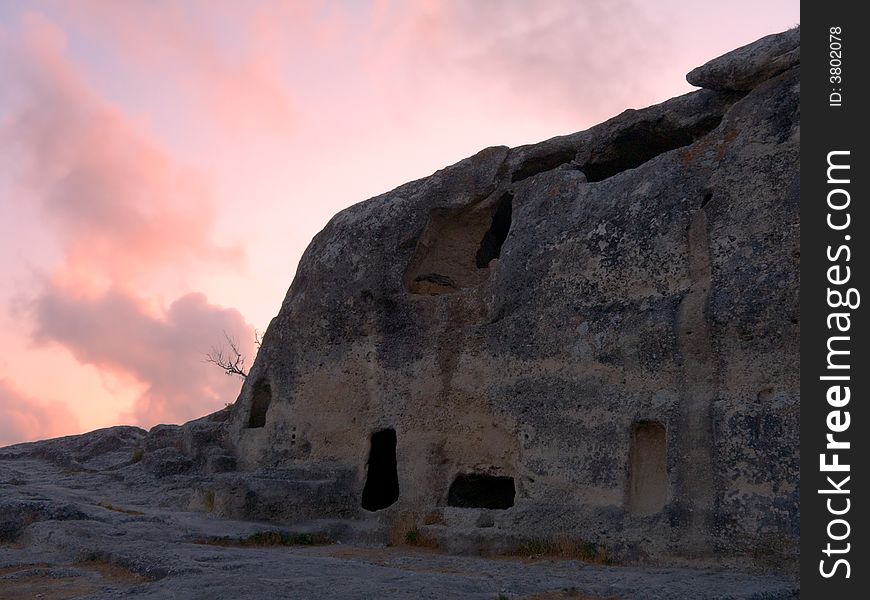 Ruins of old cave town at sunset