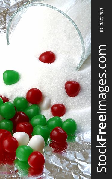 Christmas candy and a bowl of spilled sugar. Christmas candy and a bowl of spilled sugar.