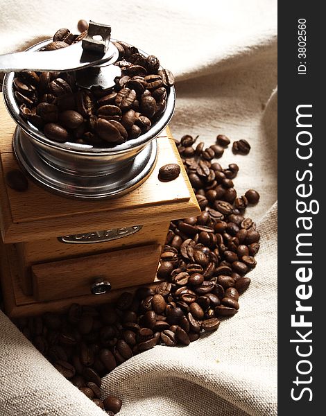 Coffee background: Close-up of a beans, cup, mill. Coffee background: Close-up of a beans, cup, mill