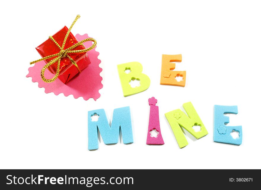 Be Mine letters isolated over white, cut out heart and a gift box