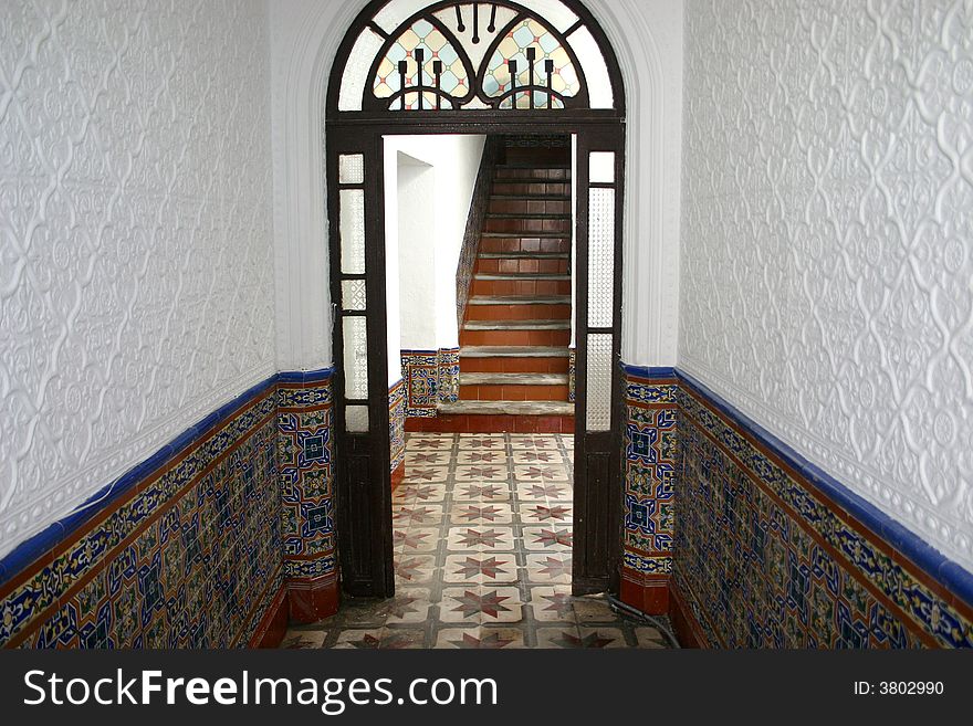 A doorway leading to stairs in a Moroccan hotel in Tangier. A doorway leading to stairs in a Moroccan hotel in Tangier