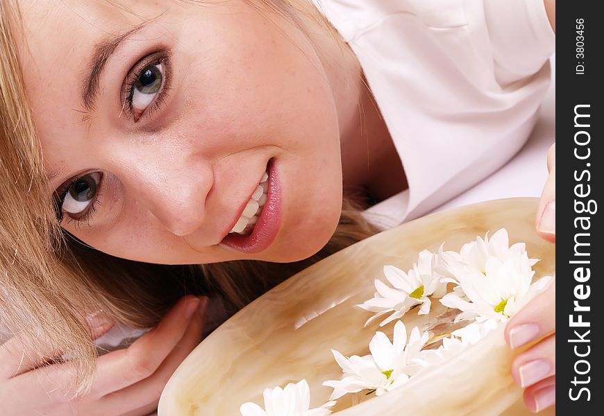 Close up of beautiful face and bowl full of flower. Close up of beautiful face and bowl full of flower