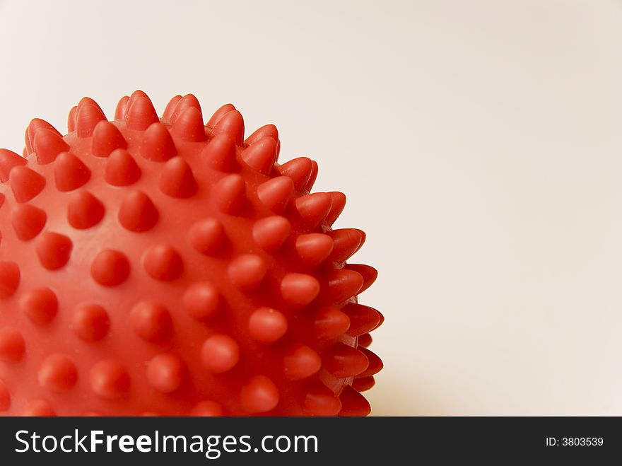 A red rubber ball with bumps. A red rubber ball with bumps