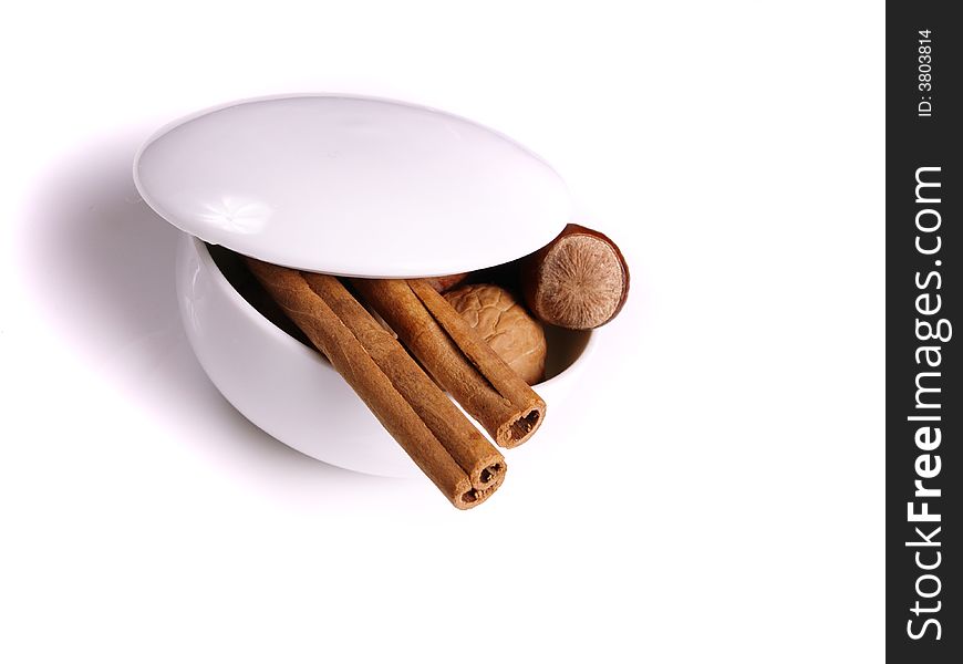 Cinnamon and nuts in the white bowl