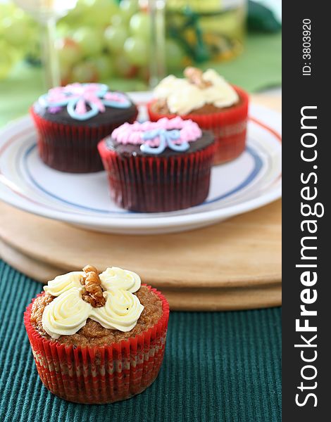 Fancy carrot and chocolate cupcakes with icing design on top