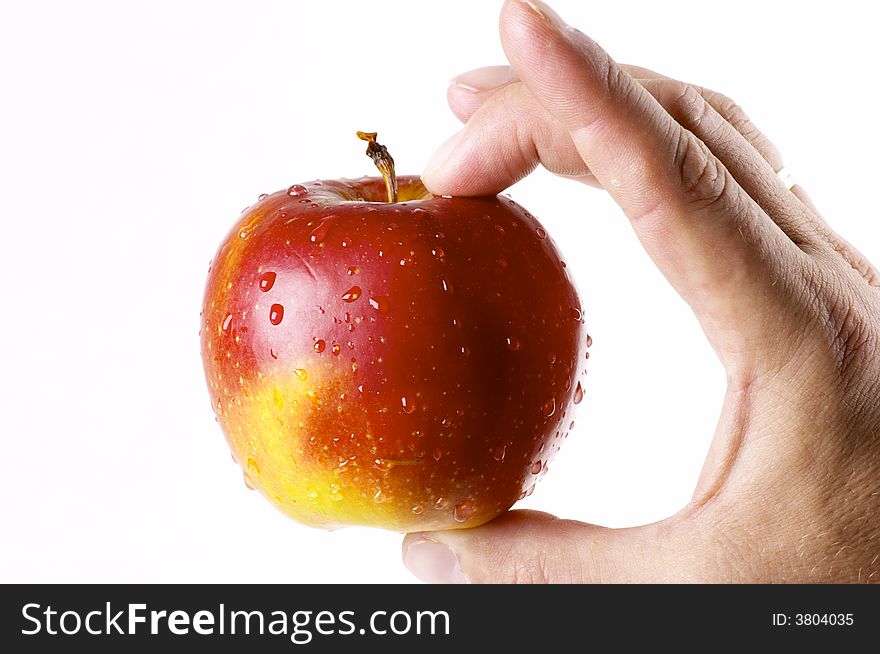 Red apple in a hand of the person