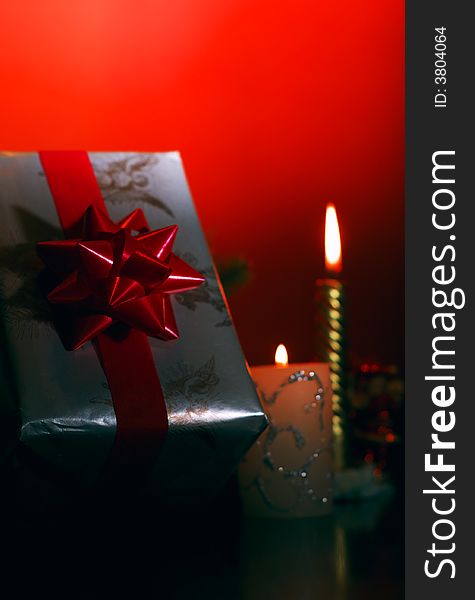 Ornaments - present, ribbon, candles on a red background. Ornaments - present, ribbon, candles on a red background