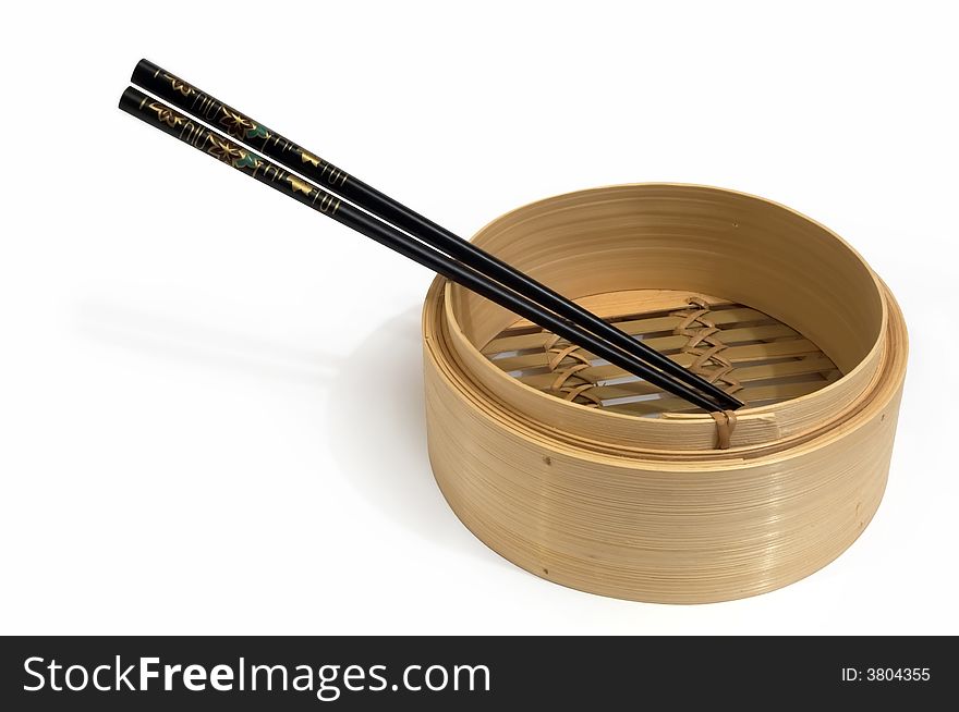 A steam basket with chopsticks on white background