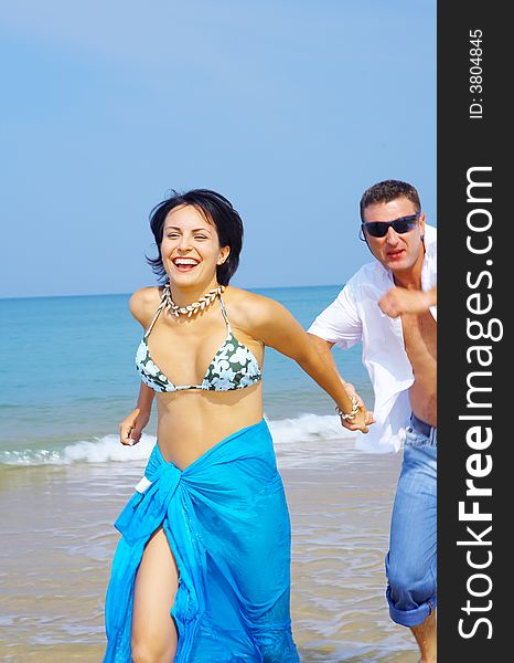 A portrait of attractive couple having fun on the beach. A portrait of attractive couple having fun on the beach