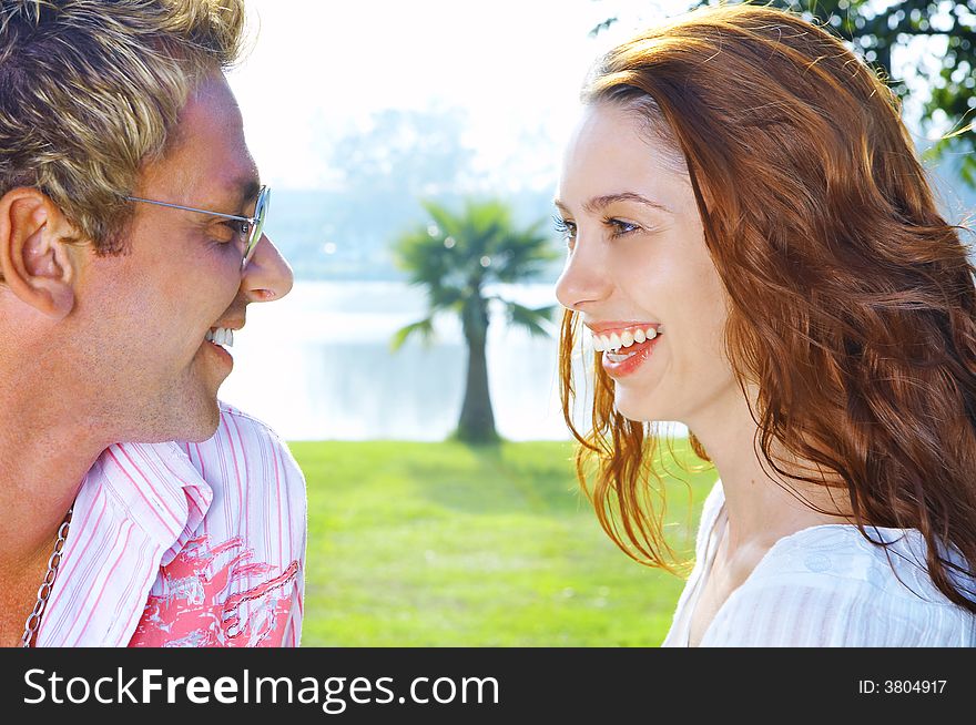 A portrait of attractive couple in summer environment. A portrait of attractive couple in summer environment