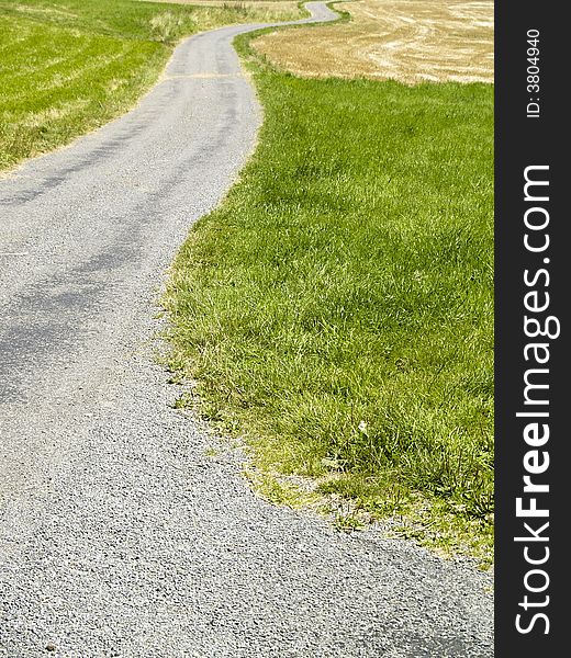 Green field and small rural path. Sunny summer day. Green field and small rural path. Sunny summer day