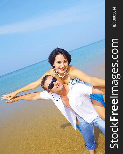 A portrait of attractive couple having fun on the beach. A portrait of attractive couple having fun on the beach