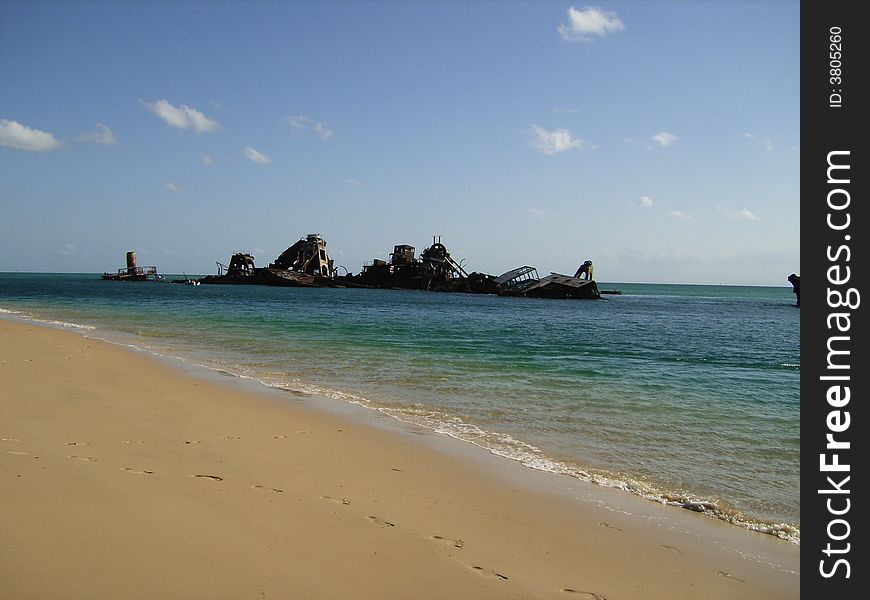 Several rusty ship wrecks at a beach