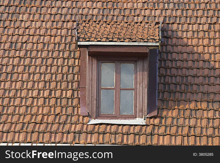 Tile roof with a window on it. Tile roof with a window on it