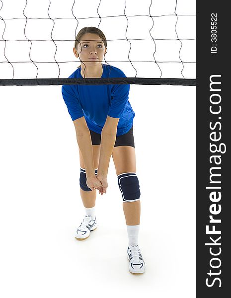 Young, beauty volleyball player. Standing in front of net and preparing to take the ball. White background. Whole body, front view. Young, beauty volleyball player. Standing in front of net and preparing to take the ball. White background. Whole body, front view