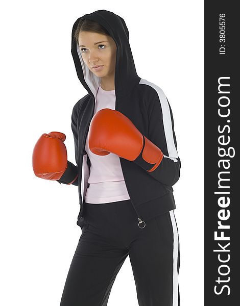 Young, hooded beauty with boxing gloves. Looking at something. White background, side view