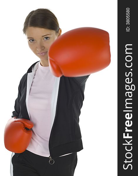 Young beauty with boxing gloves. Trying to hit somebody. Looking at camera. White background, front view. Young beauty with boxing gloves. Trying to hit somebody. Looking at camera. White background, front view