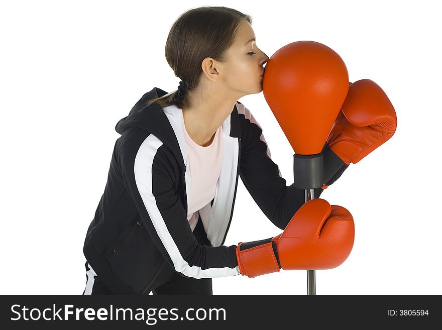 Young beauty with boxing gloves. Kissing punch bag. White background, side view. Young beauty with boxing gloves. Kissing punch bag. White background, side view