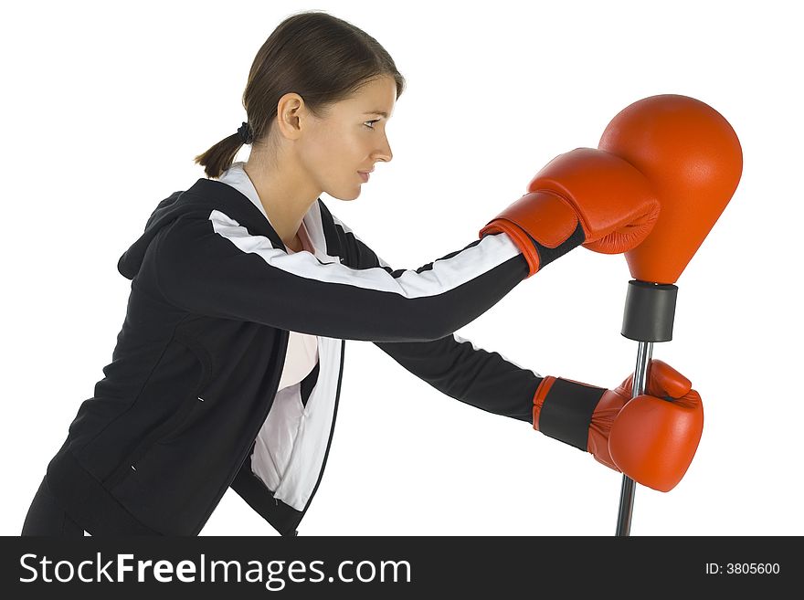 Young beauty with boxing gloves. Fighting with punch bag. White background, side view. Young beauty with boxing gloves. Fighting with punch bag. White background, side view