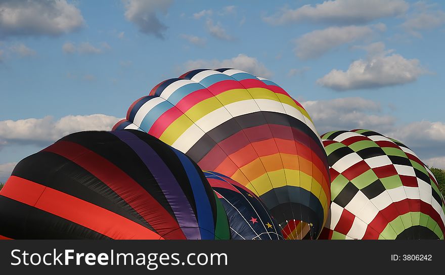 Four hot air balloons being inflated so they can lift off