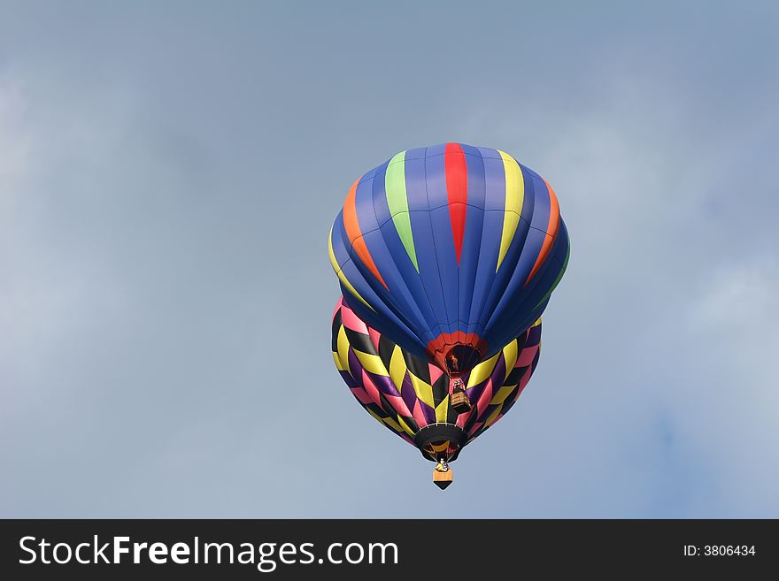 Two hot air balloons flying close together