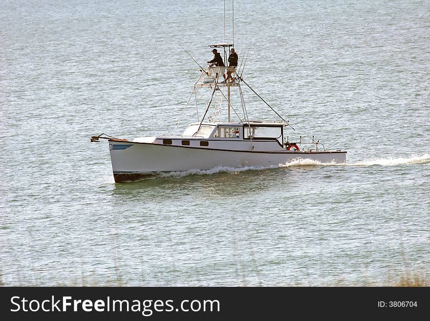 Fishing Boat with two men on it at sea