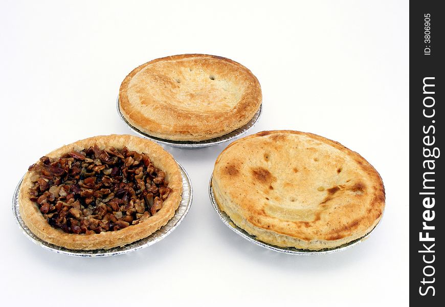 Miniature pies in tin pie pans. Miniature pies in tin pie pans.
