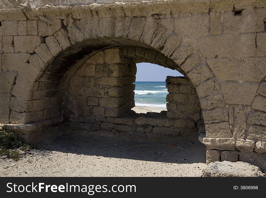 View Of Beach Through Hole In Roman Aqueduct