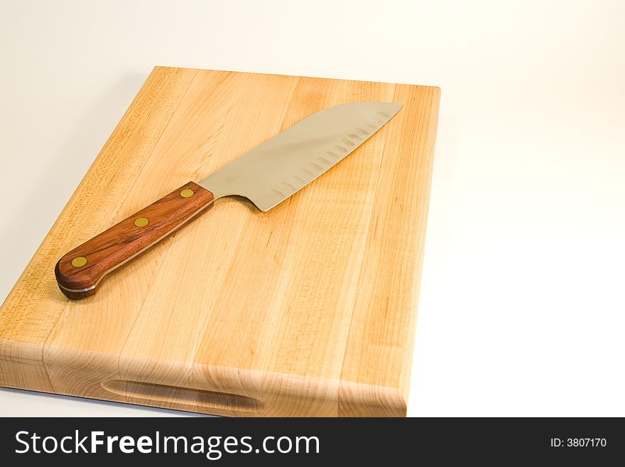 Image of a maple butcherblock cutting board and carving knife. Image of a maple butcherblock cutting board and carving knife