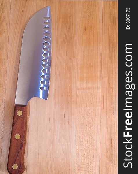 Image of a maple butcherblock cutting board and carving knife. Image of a maple butcherblock cutting board and carving knife