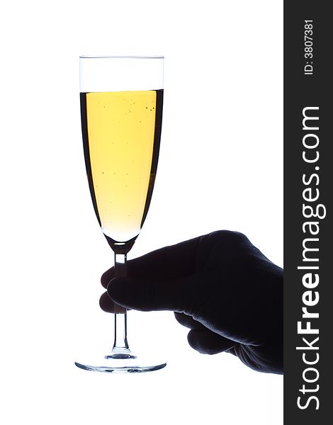 The hand holds a glass with champagne