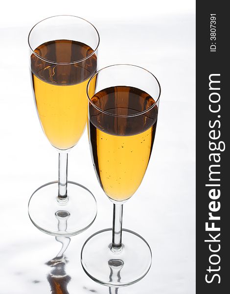Two glasses in which champagne is poured
