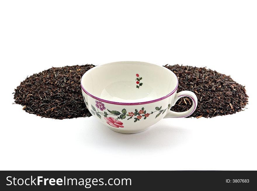 Tea leafs and cup on white background isolated