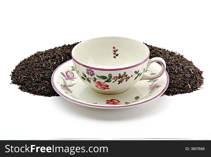 Tea leafs and cup on white background