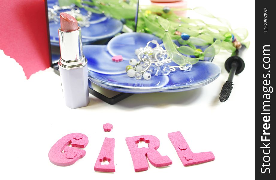 Girl tools: Jewelry and make up (lipstick, blush, eye care) and candles isolated over white